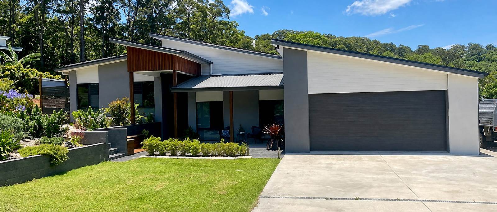 Contemporary single-storey home with a sloping roofline and landscaped frontage.