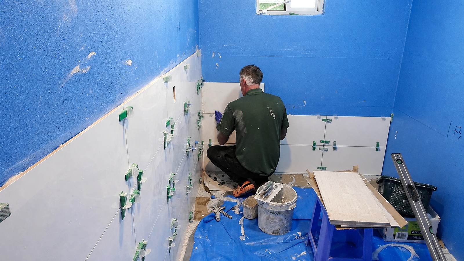 Wall tiling underway in a residential bathroom.